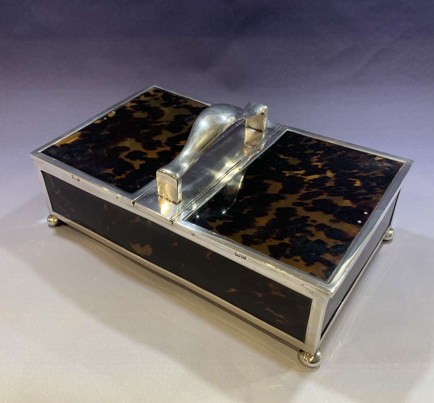 A large sterling silver and tortoiseshell two section cigar box