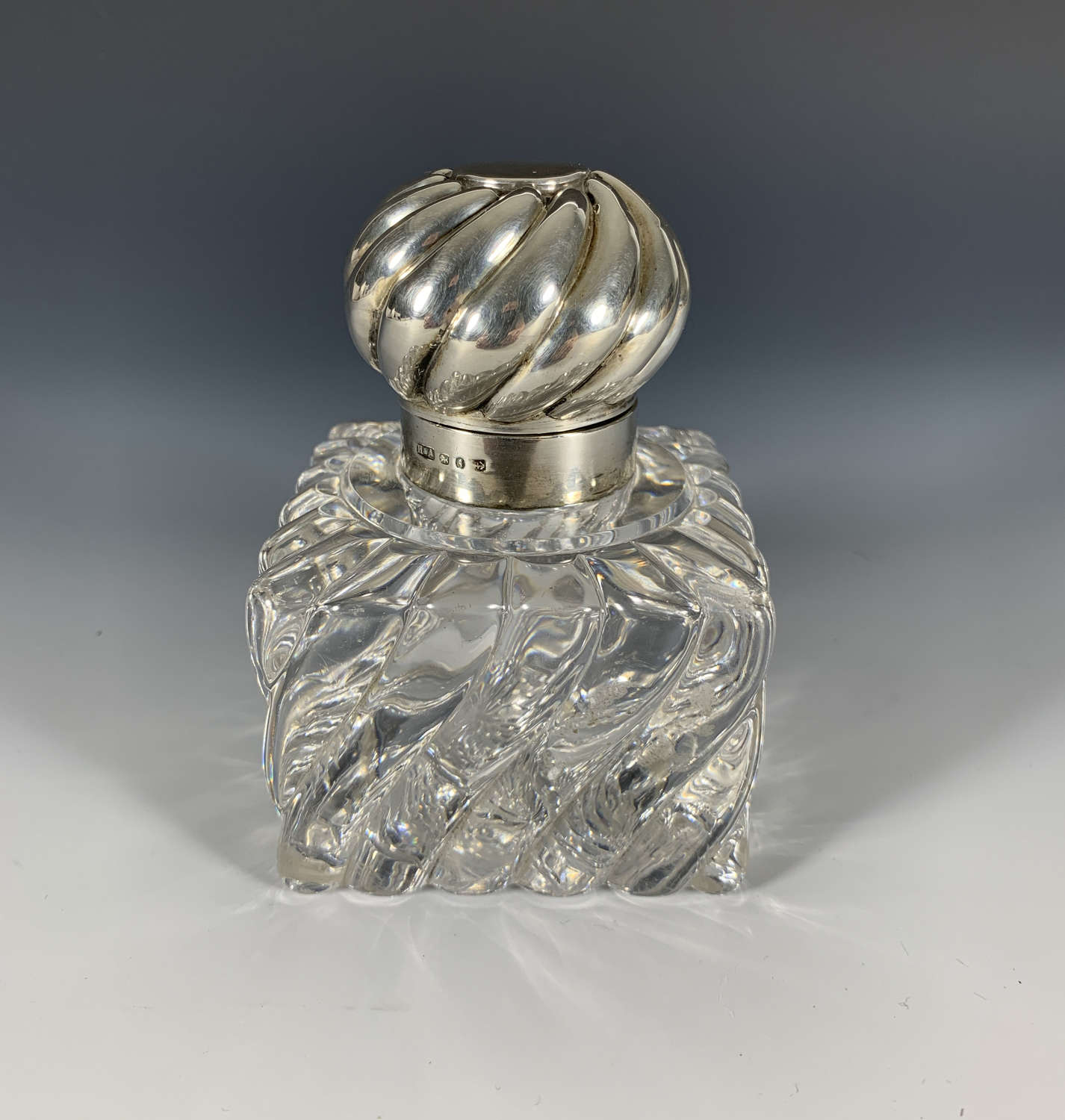 A Wrythen glass and silver inkwell