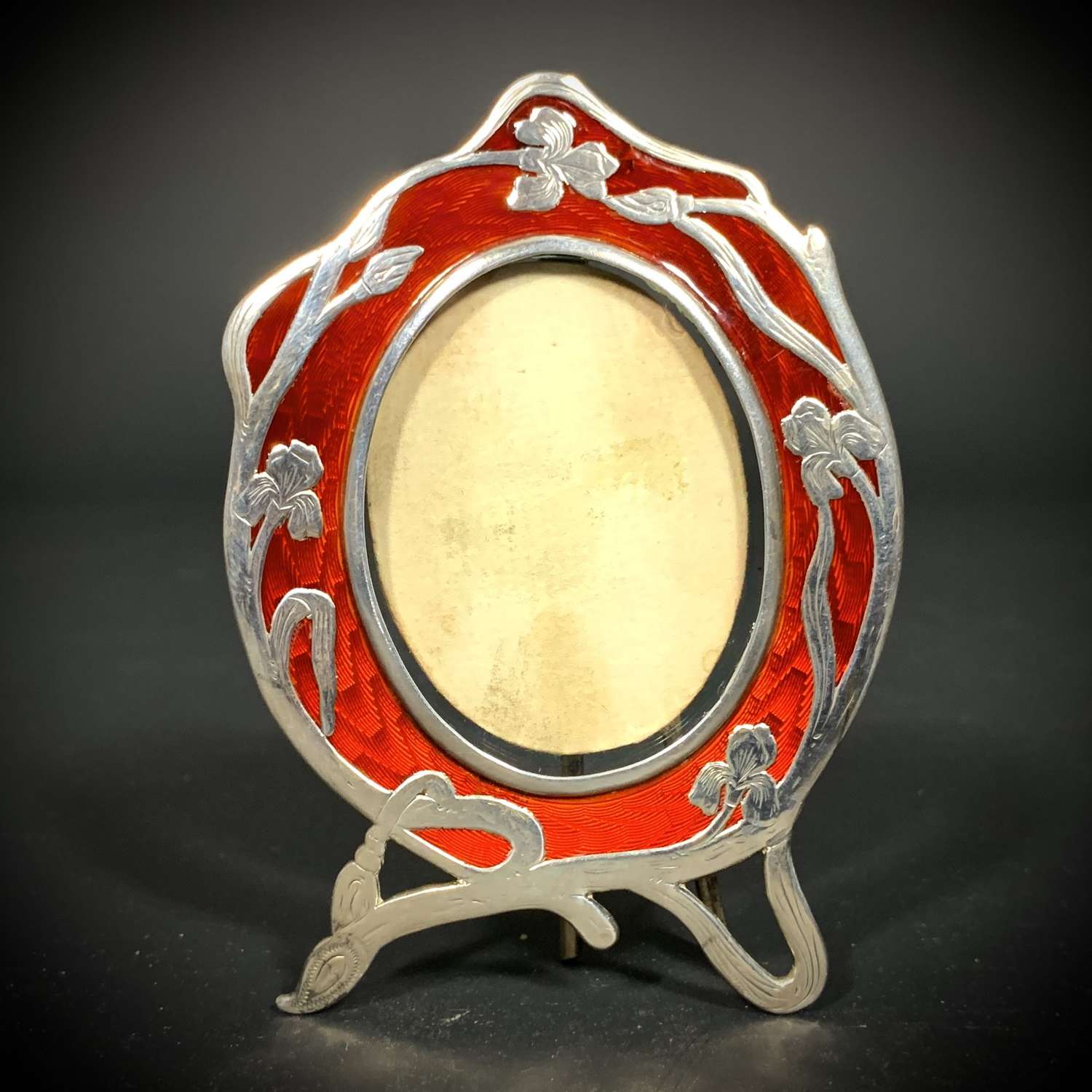 An Art Nouveau silver and red guilloche enamel photograph frame