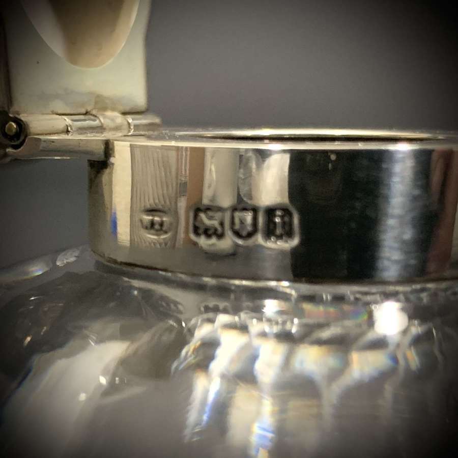 An unusual silver & glass inkwell with integral pen holder.