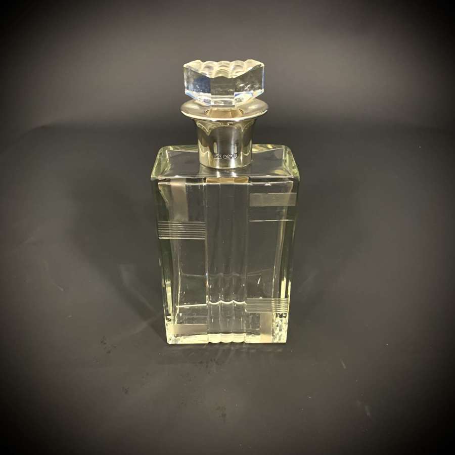 A large Art Deco Silver and moulded glass decanter