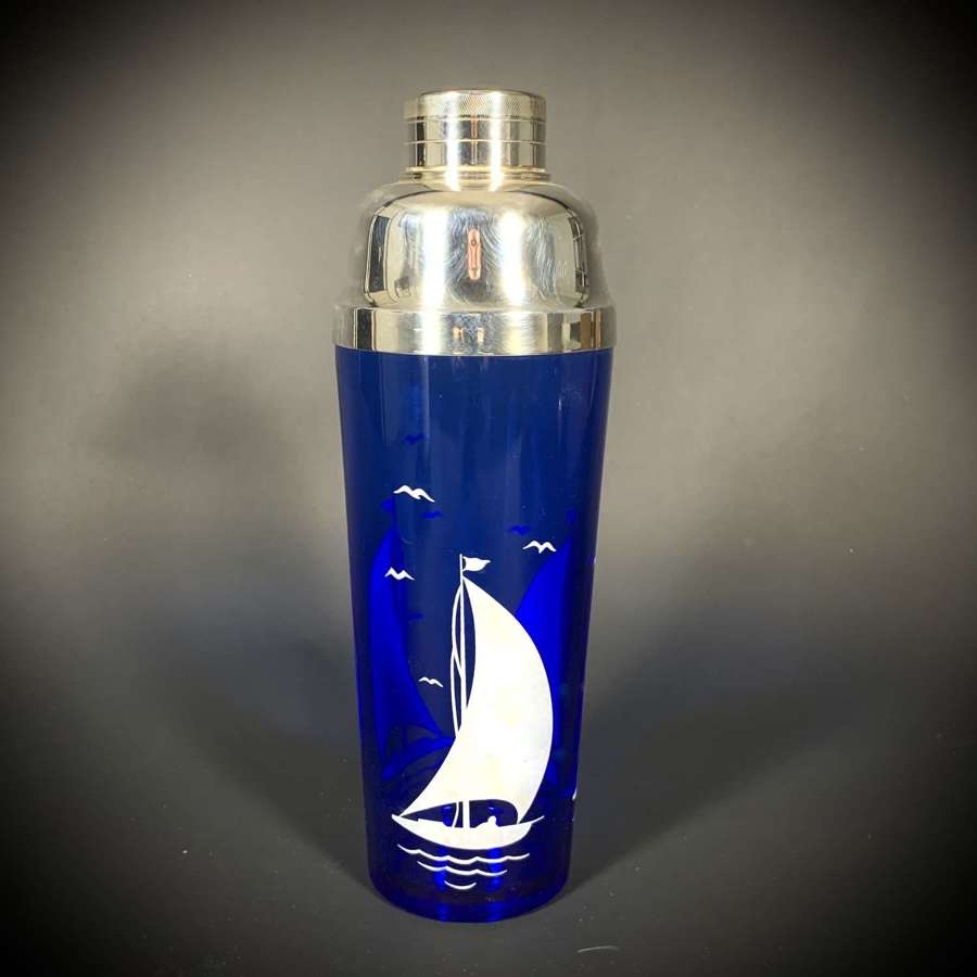 A cobalt blue glass and silver plate Yachting cocktail shaker.