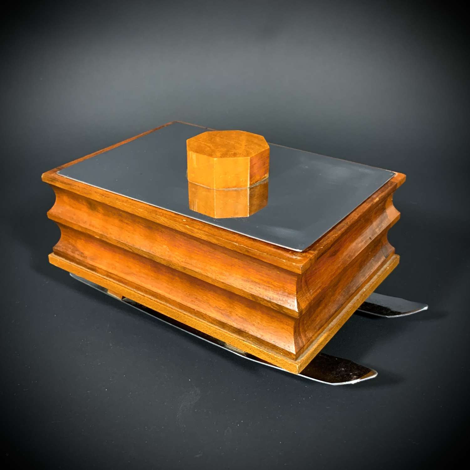 An Art Deco cigar / cigarette box fashioned as a winter sled