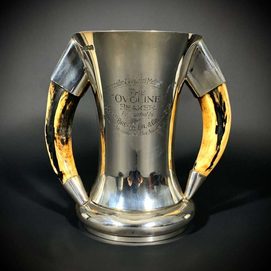 A sterling silver and boar tusk handled presentation trophy