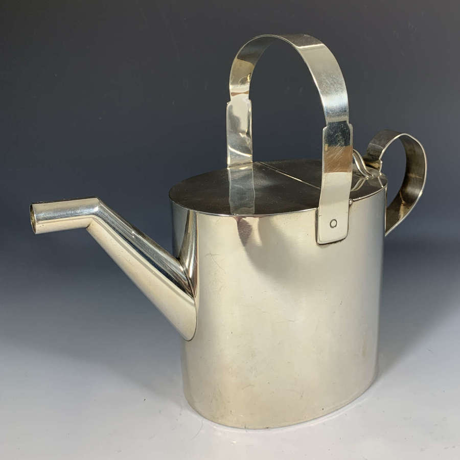 A silver watering can by Dr Christopher Dresser
