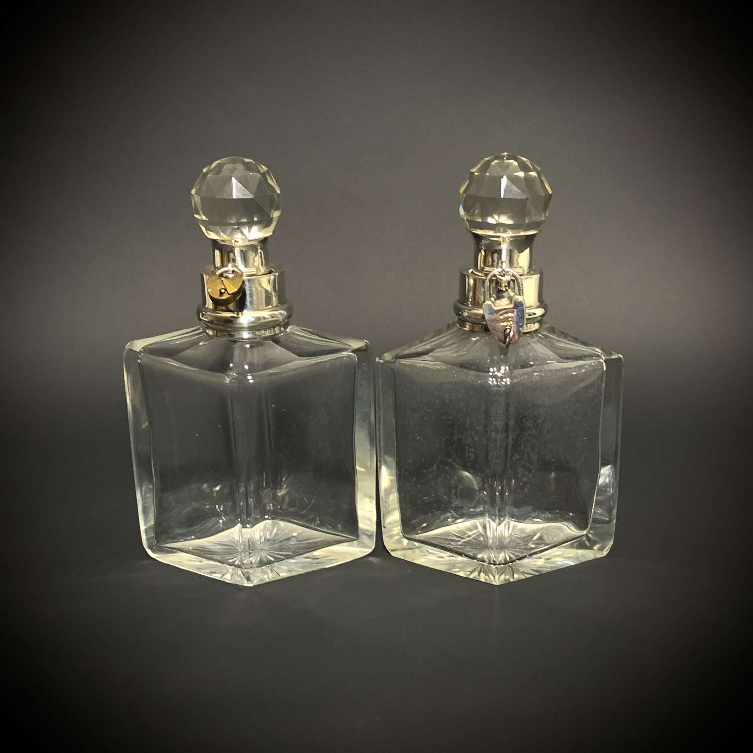 A pair of Art Deco Quadrilateral shaped locking decanters.