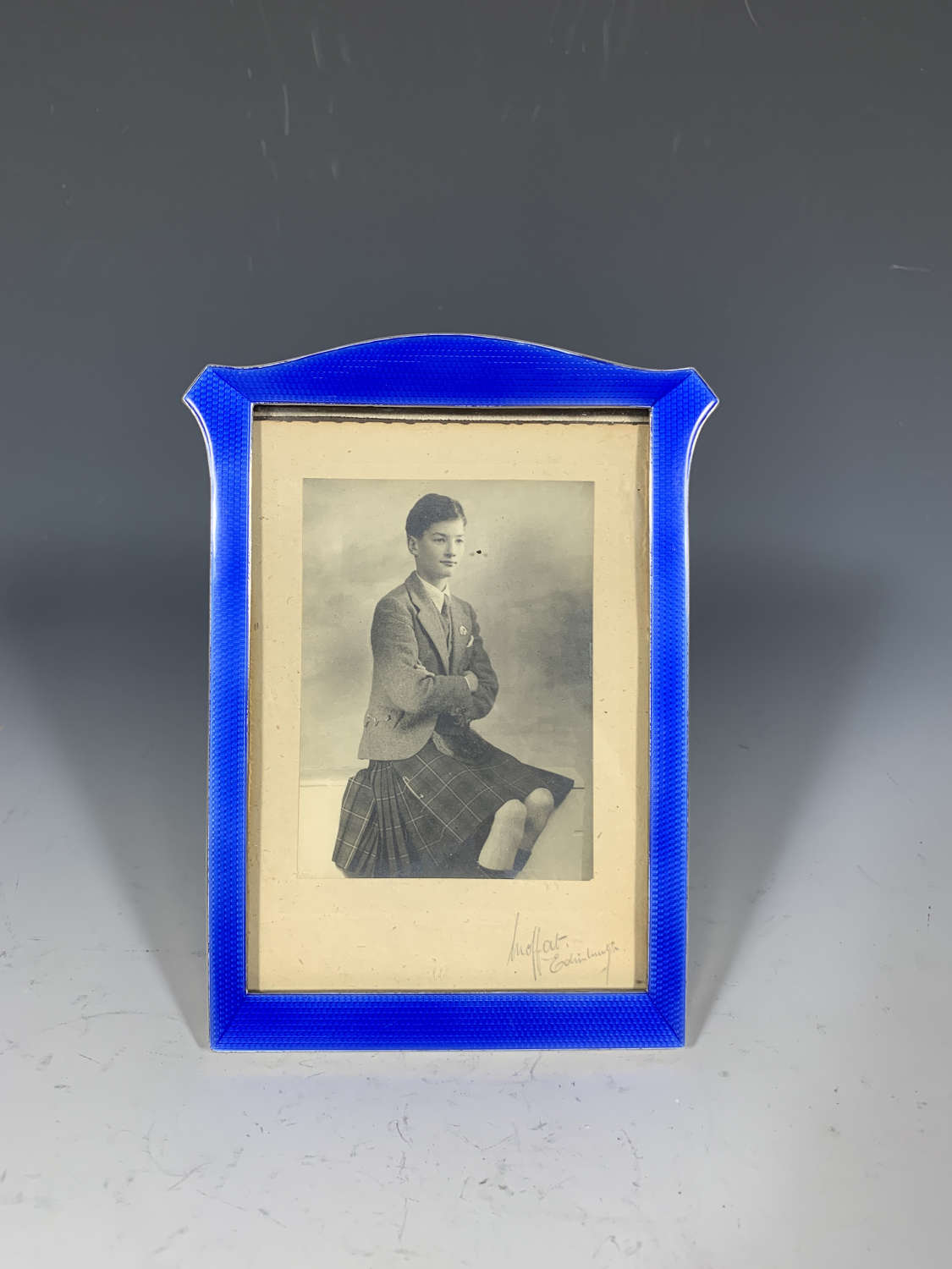 A sterling silver and navy blue guilloche enamel photograph frame