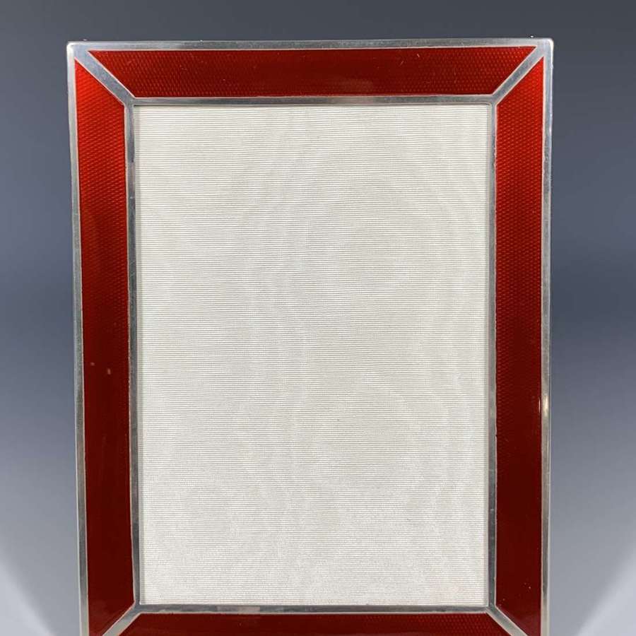 An Art Deco sterling silver and red guilloche enamel photograph frame