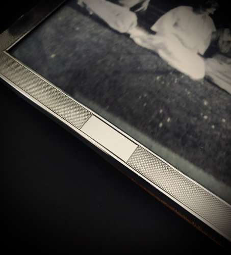 An Art Deco engine turned silver photograph frame dated 1922