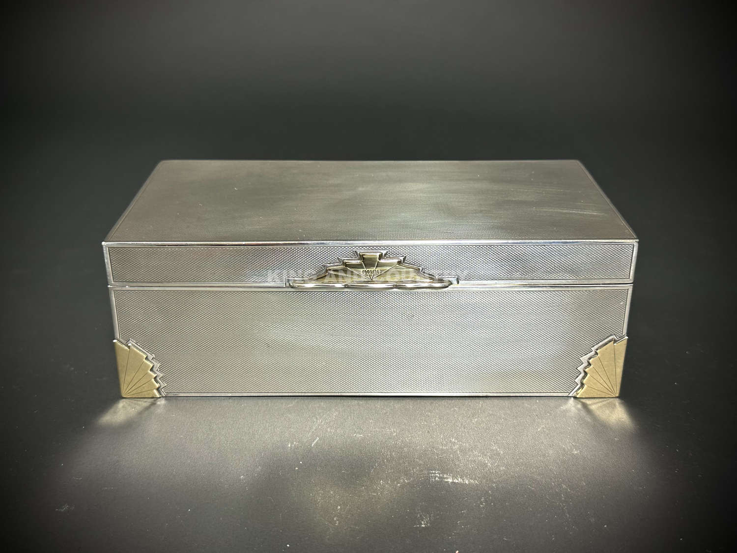 An Art Deco silver and gold cigar box by Walker & Hall