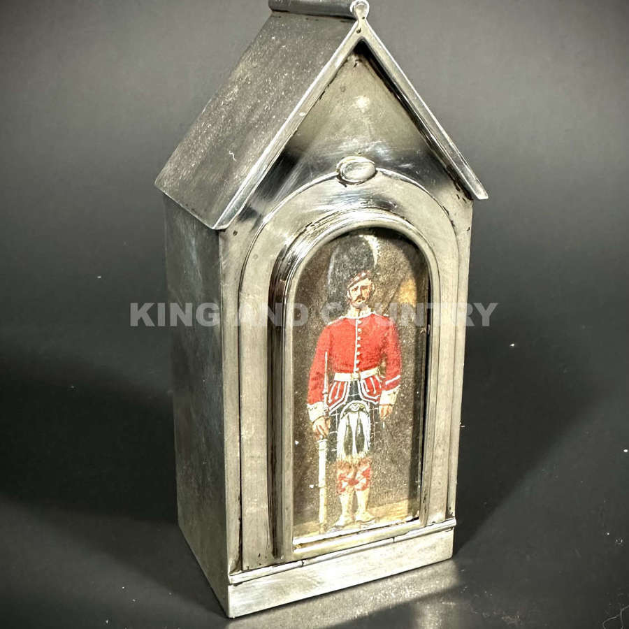 A Edwardian inkwell fashioned as a Sentry Hut with Guard