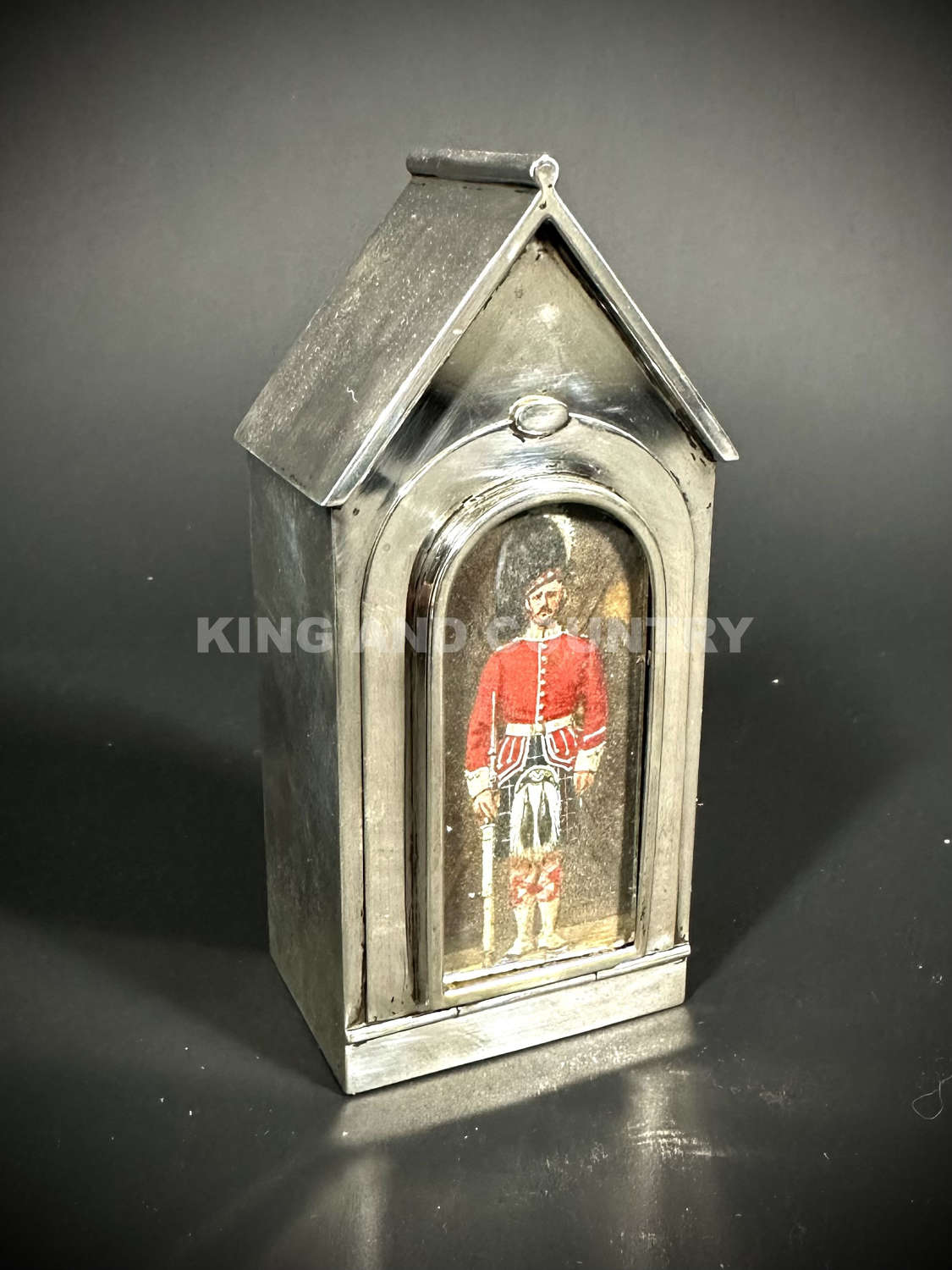 A Edwardian inkwell fashioned as a Sentry Hut with Guard