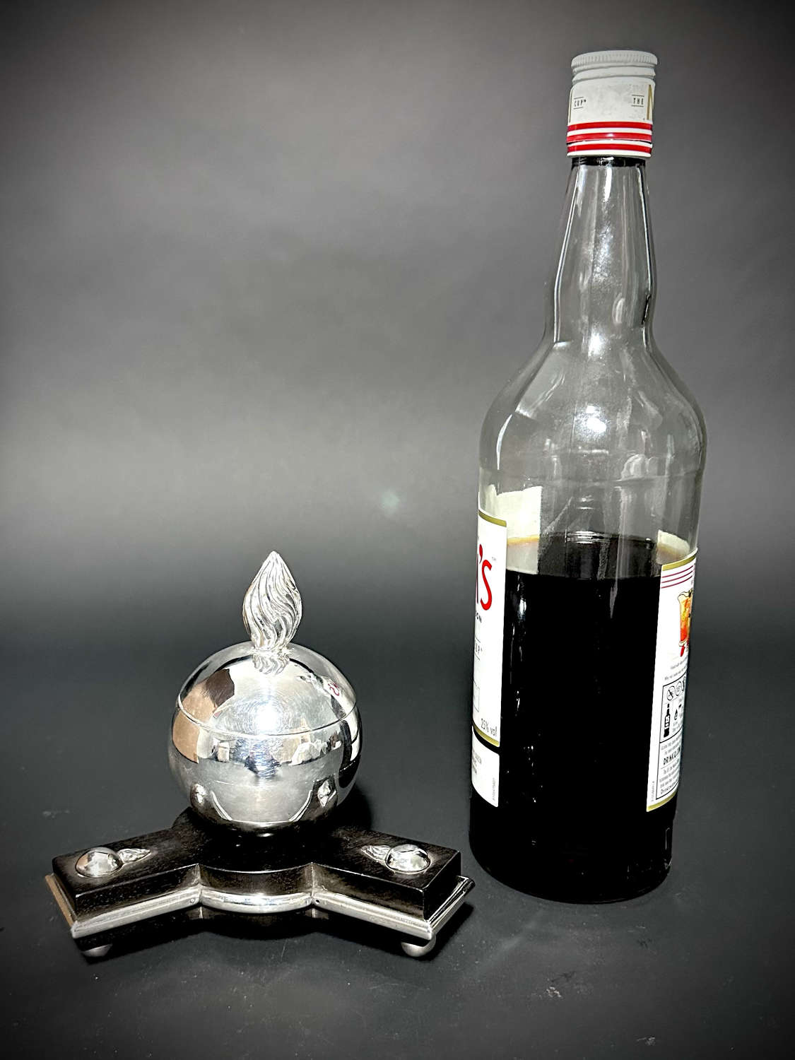 An unusual silver Grenade inkwell on an ebony base