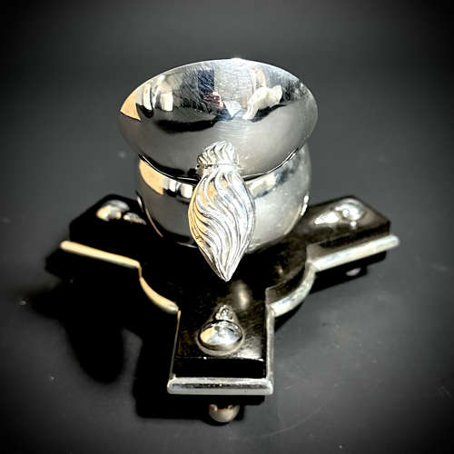 An unusual silver Grenade inkwell on an ebony base